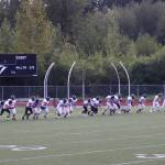 The Juneau Huskies sprint at the end of practice trying to beat Jayden Johnson, senior wide receiver and defensive back for the team, who is known for his speed. (Jasz Garrett / Juneau Empire)