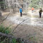 Scientists walk in a crater left behind by an iceberg stranded more than 300 years ago in a flood event caused by Black Rapids Glacier. (Photo by Ned Rozell)
