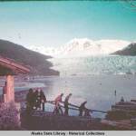 Skaters walk down steps to Mendenhall Lake. A rifle range built by the Civilian Conservation Corps is in the distance to the left. (ASL-P421-383)