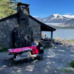 A gathering of friends rent Skaters Cabin on Mendenhall Lake from the U.S. Forest Service on a sunny day in July of 2024. The cabin and the West Glacier Trail beyond it were Civilian Conservation Corps projects. (Laurie Craig / Juneau Empire)