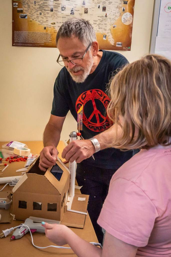 A Sitka youth and instructor build an energy efficient model home during a Southeast Renewable Energy Camp, a week-long exploration of Sitkas past, present and future energy resources. (Photo by Ryan Morse)