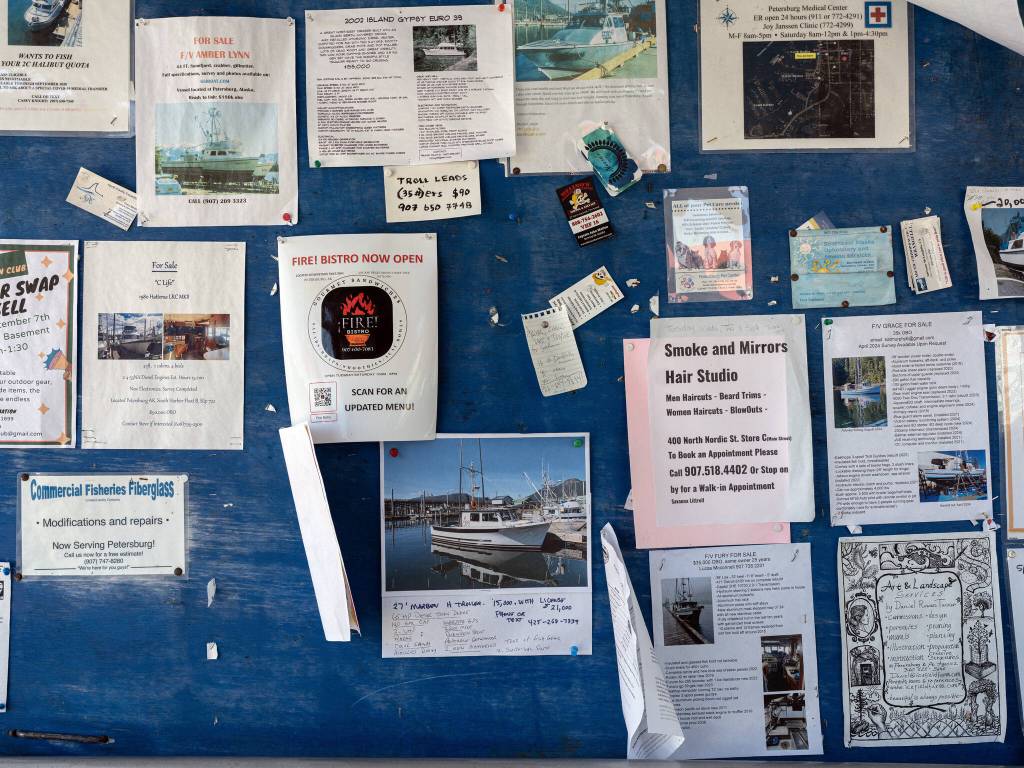 A bulletin board with notices of fishing boats for sale at North Harbor in Petersburg on Aug. 16, 2024. Over the last few years, the $6 billion Alaskan wild seafood market has been ensnared in a mix of geopolitics, macroeconomics, changing ocean temperatures and post-Covid whiplash that piled on top of long-building vulnerabilities in the business model. (Ash Adams/The New York Times)
