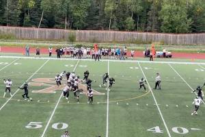 Caleb Ziegenfuss (left) looks to pass for the Juneau Huskies during Saturdays road game against South Anchorage High School. (Screenshot from Juneau Huskies Football livestream)
