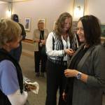 Melanee Tiura (right), one of three finalists to be the new CEO at Bartlett Regional Hospital, talks with an employee during a meet-and-greet at the hospital on Aug. 26. (Mark Sabbatini / Juneau Empire)