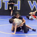 Adriana Blanton tries a hold against Fiona McFarlin during a co-ed wrestling camp at the Juneau Wrestling Center on July 28. (Mark Sabbatini / Juneau Empire)