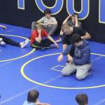 Wrestling coach Weston Wichman shows William Dapcevich, a Juneau high school wrestler, a technique during a July 28 camp at the Juneau Wrestling Center. (Mark Sabbatini / Juneau Empire)