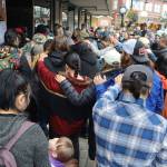 Friends and family of Steven Kissack place their hands on each others shoulders in a show of support at a storefront on Front Street where he often slept during a memorial gathering Sunday, Aug. 25, 2024. (Mark Sabbatini / Juneau Empire file photo)