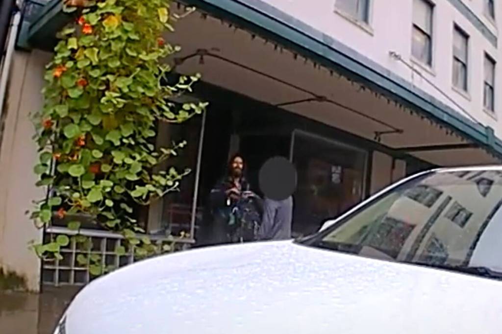 A woman talks to Steven Kissack, defying orders by police not to do so, during a confrontation on Front Street on July 15. (Screenshot from JPD bodycam video)