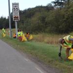 U.S. Forest Service workers clean up trash on Egan Drive near the Fred Meyer intersection Wednesday morning as a tribute on the anniversary of the Sept. 11, 2001, terrorist attacks. (Mark Sabbatini / Juneau Empire)