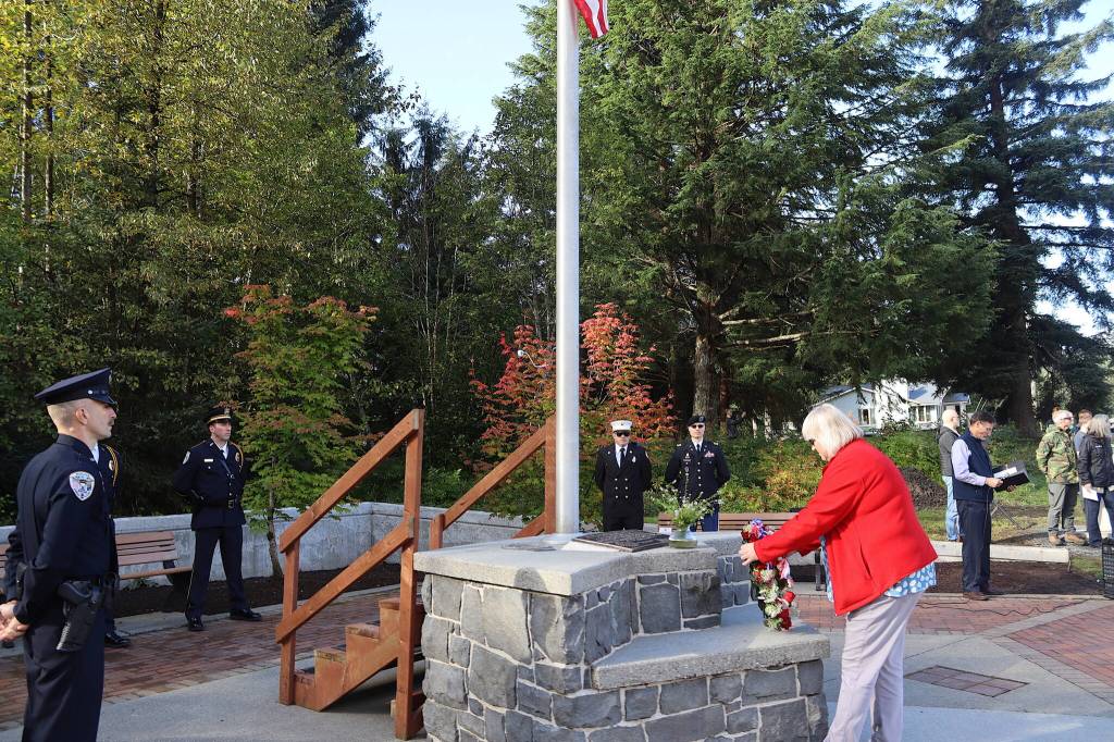 Juneau Mayor Beth Weldon places a wreath on the September 11th Memorial at Riverside Rotary Park during a commemoration ceremony Wednesday morning. (Mark Sabbatini / Juneau Empire)