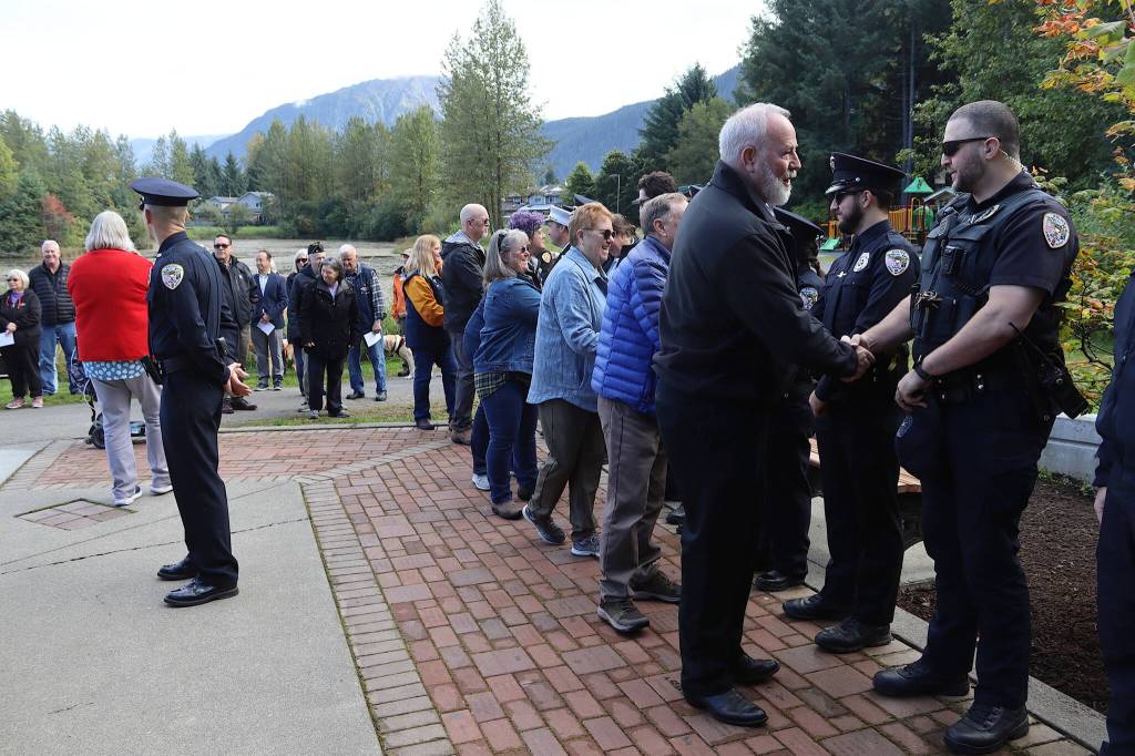 Juneau police officers receive thanks from attendees at a Sept. 11 commemoration ceremony Wednesday morning. (Mark Sabbatini / Juneau Empire)
