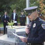Officer Ron Shriver of the Juneau Police Department explains the history and features of the September 11th Memorial at Riverside Rotary Park during a commemoration ceremony Wednesday morning. (Mark Sabbatini / Juneau Empire)