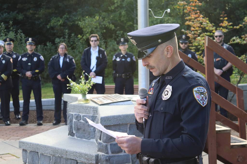 Officer Ron Shriver of the Juneau Police Department explains the history and features of the September 11th Memorial at Riverside Rotary Park during a commemoration ceremony Wednesday morning. (Mark Sabbatini / Juneau Empire)