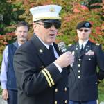 Brandon Bagwell, program manager for Capital City Fire/Rescues Aircraft Rescue Fire Fighting unit, talks about some of the firefighters who lost their lives in the Sept. 11, 2001, terrorist attacks during a commemoration ceremony at Riverside Rotary Park on Wednesday morning. (Mark Sabbatini / Juneau Empire)