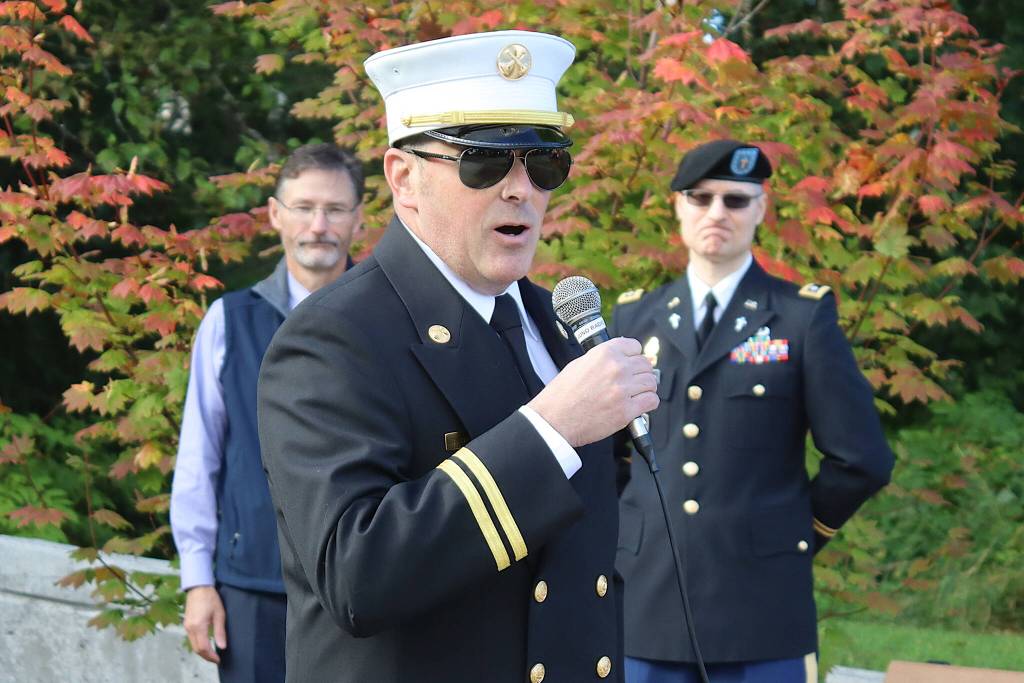 Brandon Bagwell, program manager for Capital City Fire/Rescues Aircraft Rescue Fire Fighting unit, talks about some of the firefighters who lost their lives in the Sept. 11, 2001, terrorist attacks during a commemoration ceremony at Riverside Rotary Park on Wednesday morning. (Mark Sabbatini / Juneau Empire)