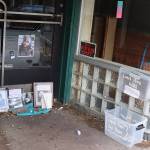 A memorial in the doorway on Front Street where Steven Kissack was sitting when he was approached by a police officer on July 15, resulting in a 16-minute encounter that ended with him being fatally shot, includes photos, written messages and a food for friends dropoff box on Saturday morning. (Mark Sabbatini / Juneau Empire)