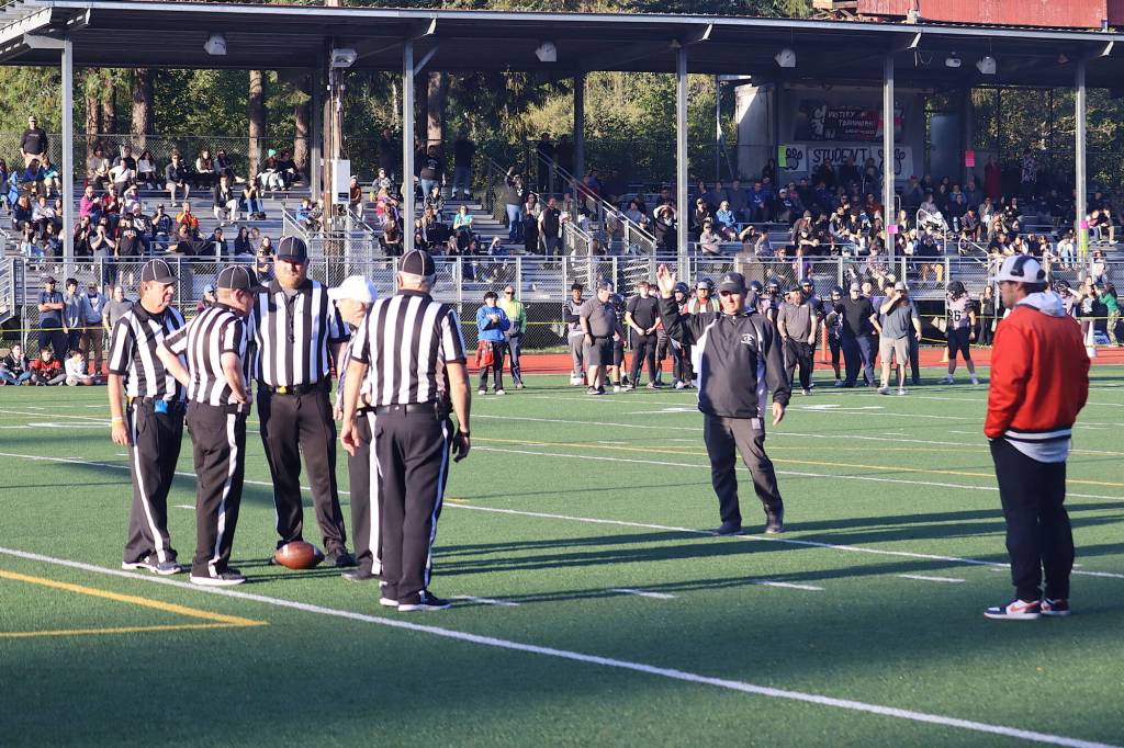 Officials huddle in the end zone with 81 seconds left in Saturdays game between Juneau-Douglas High School: Yadaa.at Kalé and West Anchorage High School  as the head coaches for both teams watch  trying to determine if a fumble on a play by West Anchorage should result in a safety or Juneau getting the ball on the 1-yard line. The decision was a safety, resulting in Juneau getting the ball deep in its territory with the score 28-27, rather than at the 1-yard line with a 28-25 deficit. (Mark Sabbatini / Juneau Empire)