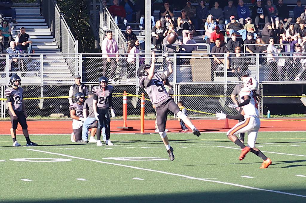 Sage Schultz (5) intercepts a pass for Juneau-Douglas High School: Yadaa.at Kalé in the second half of Saturdays game against West Anchorage High School at Adair-Kennedy Memorial Park. (Mark Sabbatini / Juneau Empire)