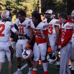 Ariel Sanchez (2) is congratulated by West Anchorage High School teammates after catching a Hail Mail touchdown pass at the end of the first half against Juneau-Douglas High School: Yadaa.at Kalé on Saturday at at Adair-Kennedy Memorial Park. (Mark Sabbatini / Juneau Empire)