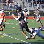 Juneau-Douglas High School: Yadaa.at Kalés Jayden Johnson (4) breaks free of a tackler as he runs a pass in for a touchdown against West Anchorage High School on Saturday at Adair-Kennedy Memorial Park. (Mark Sabbatini / Juneau Empire)