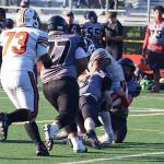A fourth-and-inches play by West Anchorage High School is stopped short of the first down by the Juneau Huskies Ethan Van Kirk (3) and Hyrum Fish (12) near the end of Saturdays game at Adair-Kennedy Memorial Park. (Mark Sabbatini / Juneau Empire)