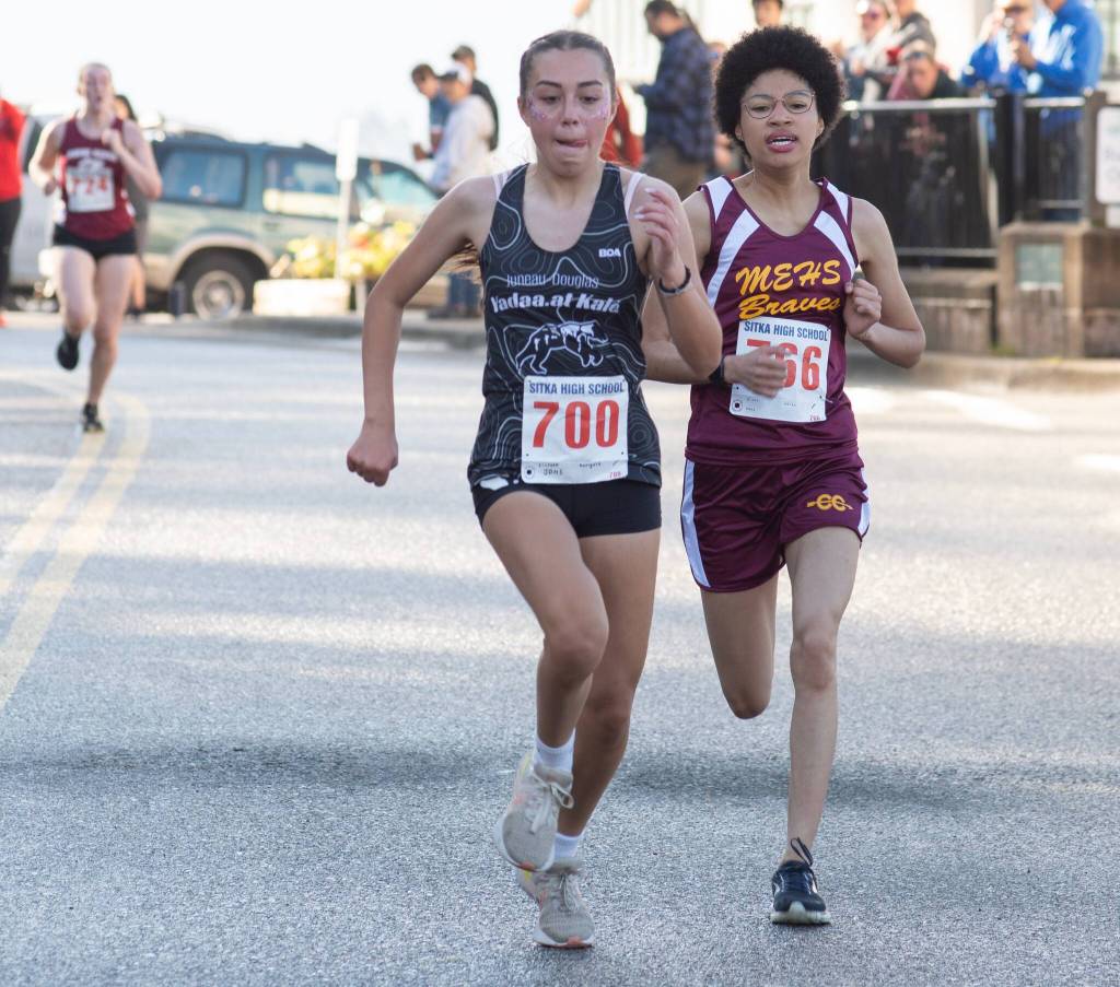 Juneau-Douglas High School: Yadaa.at Kalé sophomore Marigold Lindoff sprints to the finish in front of Mt. Edgecumbe senior Aries Bioff during the Sitka Cross Country Invitational on Saturday. (James Poulson / Sitka Sentinel)