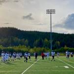 The Juneau Huskies football team warms up in practice this week under direction of freshman assistant coach and manager Jaasyah Crowley on the Thunder Mountain Middle School field. (Klas Stolpe /For the Juneau Empire)