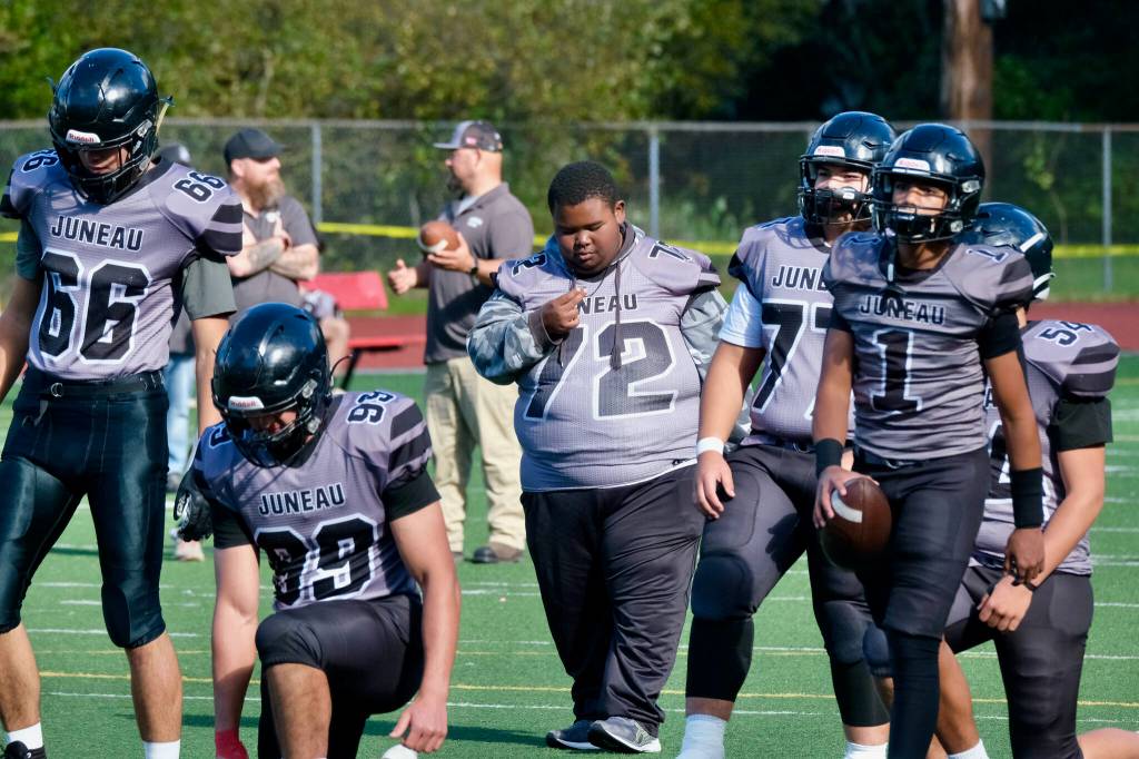 Juneau-Douglas High School: Yadaa.at Kalé freshman assistant coach and manager Jaasyah Crowley (72) directs varsity warmups before the Juneau Huskies’ game against West Anchorage High School last Saturday at Adair-Kennedy Memorial Park. (Klas Stolpe / For the Juneau Empire)