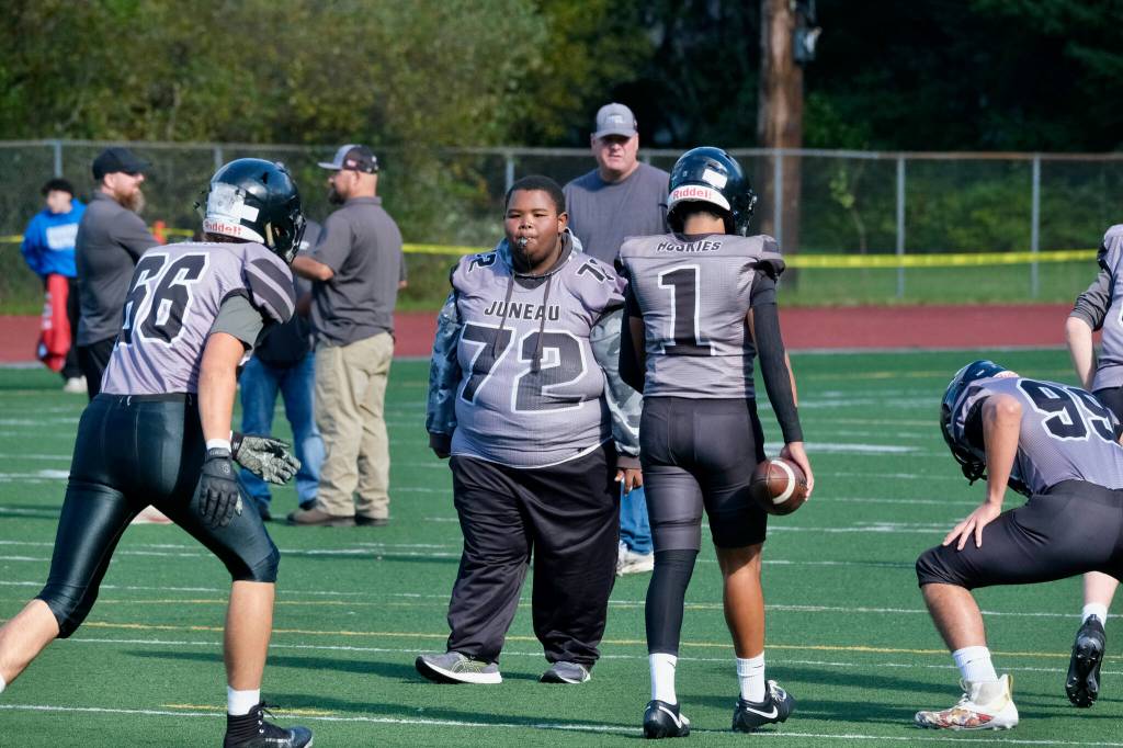 Juneau-Douglas High School: Yadaa.at Kalé freshman assistant coach and manager Jaasyah Crowley (72) directs varsity warmups before the Juneau Huskies’ game against West Anchorage High School last Saturday at Adair-Kennedy Memorial Park. (Klas Stolpe / For the Juneau Empire)
