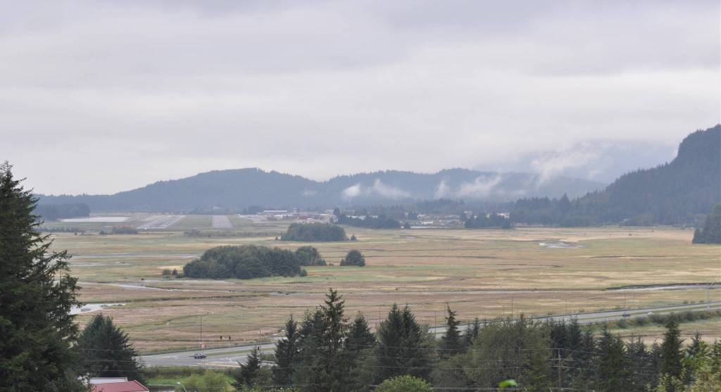 A view from the Vanderbilt Hill area of the wide sweep of tidelands by Lemon Creek with forested dredge islands and Juneau International Airport on the left. Egan Drive is in the foreground. (Laurie Craig / Juneau Empire)