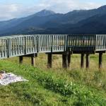 Sarah Dittman paints a watercolor scene of the wetlands as Ela Gonzalez watches. They are seated beside the Egan Drive pullout near the Rotary Club observation deck. (Laurie Craig / Juneau Empire)