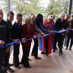Tribal, academic and political leaders cut a ribbon to mark the opening of the Áakʼw Tá Hít building at the University of Alaska Southeast on Friday. (Mark Sabbatini / Juneau Empire)