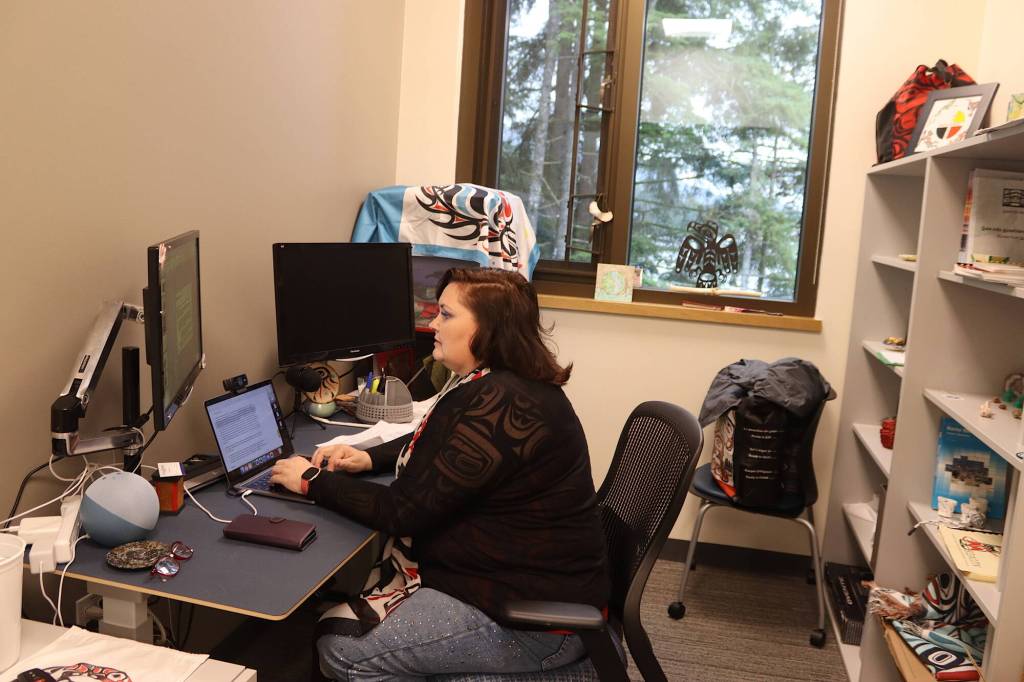 Wendy Kah Skaahluwaa Todd works on a presentation about using traditional as well as Western knowledge in healthcare in her office at the new Áakʼw Tá Hít building at the University of Alaska Southeast on Friday. (Mark Sabbatini / Juneau Empire)