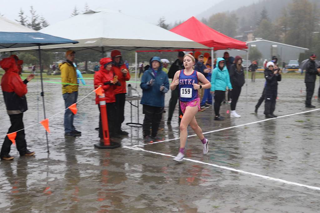 Sitka High Schools Marina Dill crosses the finish line to win the girls 5K at the Capital City Invite on Saturday at Savikko Park. (Mark Sabbatini / Juneau Empire)