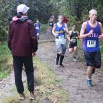 Boys from high schools throughout Southeast Alaska run along the Treadwell Mine Historic Trail during the Capital City Invite 5K on Saturday. (Mark Sabbatini / Juneau Empire)