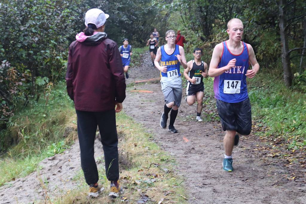 Boys from high schools throughout Southeast Alaska run along the Treadwell Mine Historic Trail during the Capital City Invite 5K on Saturday. (Mark Sabbatini / Juneau Empire)