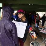 Students prepare to take signs showing support for runners in the Capital City Invite out along the Treadwell Mine Historic Trail on Saturday morning. (Mark Sabbatini / Juneau Empire)