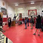 Kake residents and guests, including U.S. Navy personnel, stand for the national anthem during a ceremony Saturday where the Navy offered a formal apology for the bombardment of the village in 1869. (Laurie Craig / Juneau Empire)