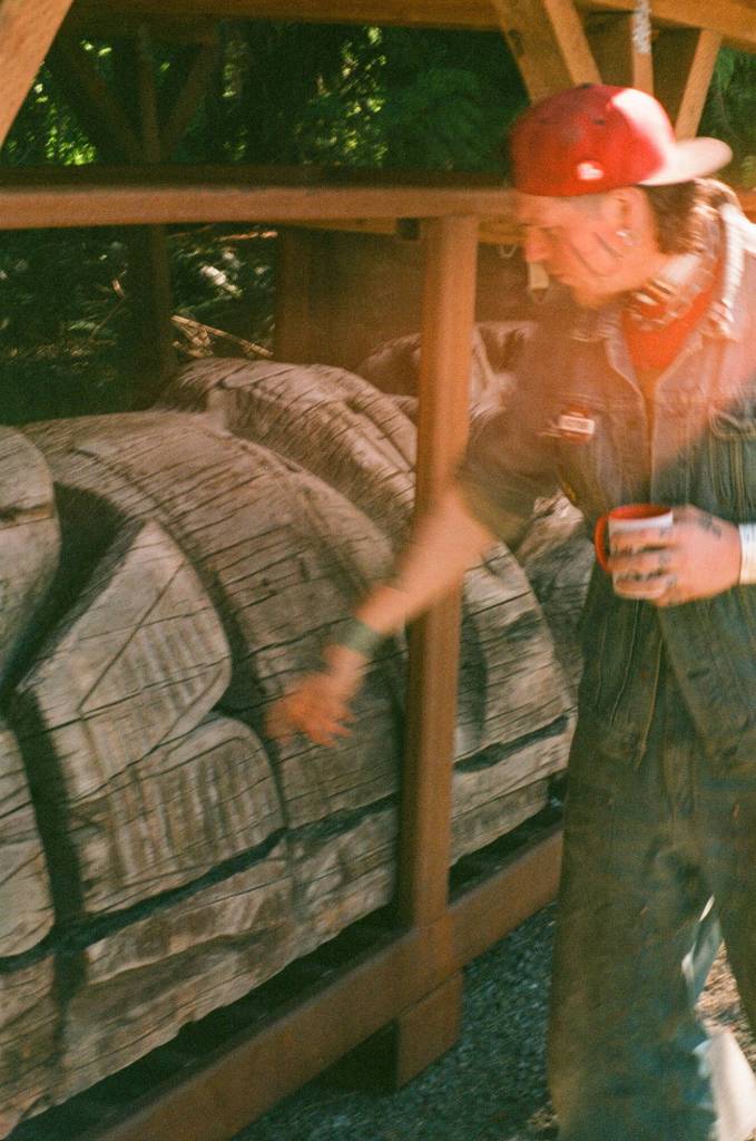 In Kasaan, carver Eric Hamar points to where a recently returned totem had been struck by lightning due to a metal pole inserted in its core. (Photo by Addy Mallott)