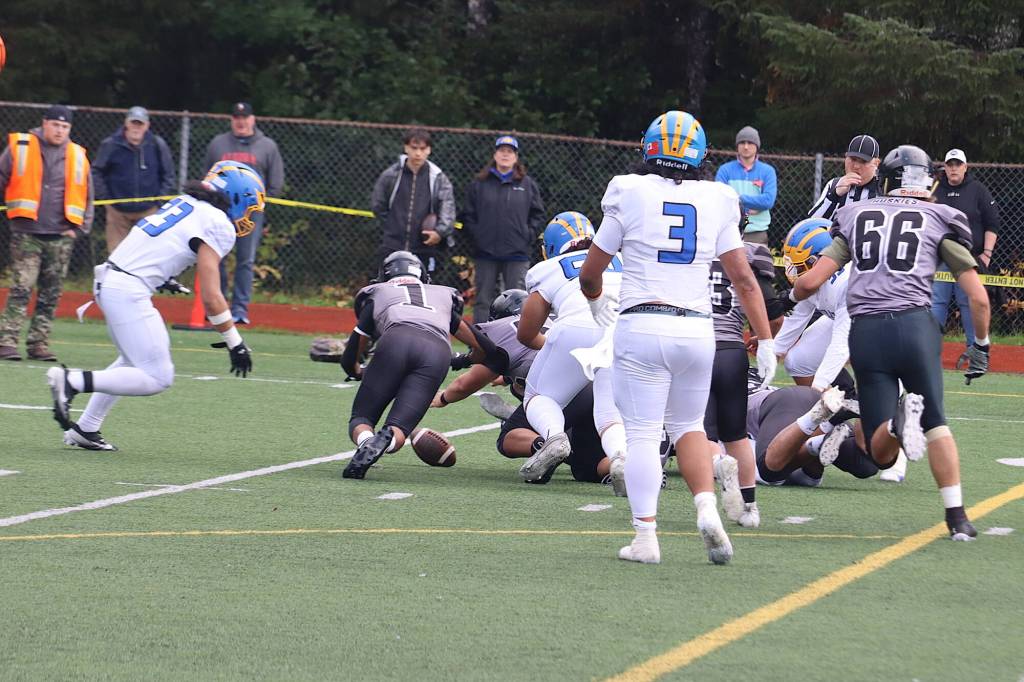 Juneau Huskies players jump on a fumble by Bartlett High School early in the first quarter of Saturdays game at Adair-Kennedy Memorial Park. (Mark Sabbatini / Juneau Empire)