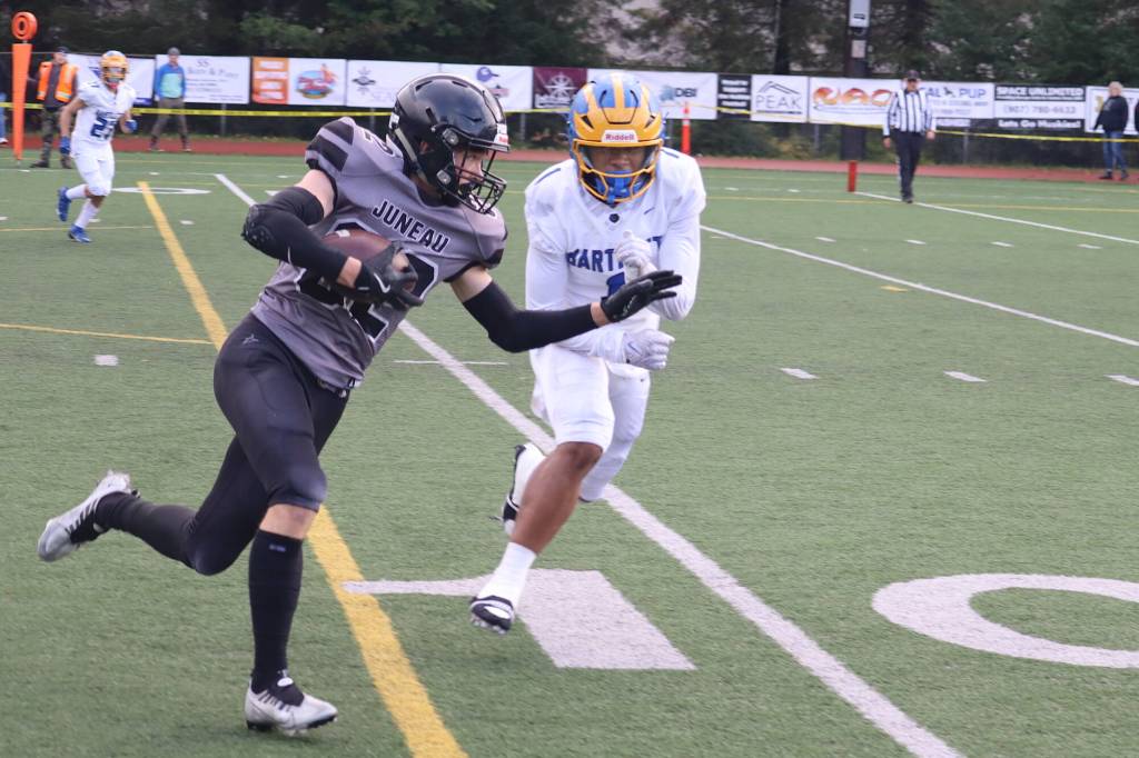 Johnathyn Kestel runs a first-quarter catch inside the Bartlett High School 10-yard line during the first quarter of Saturdays game at Adair-Kennedy Memorial Park. (32) (Mark Sabbatini / Juneau Empire)