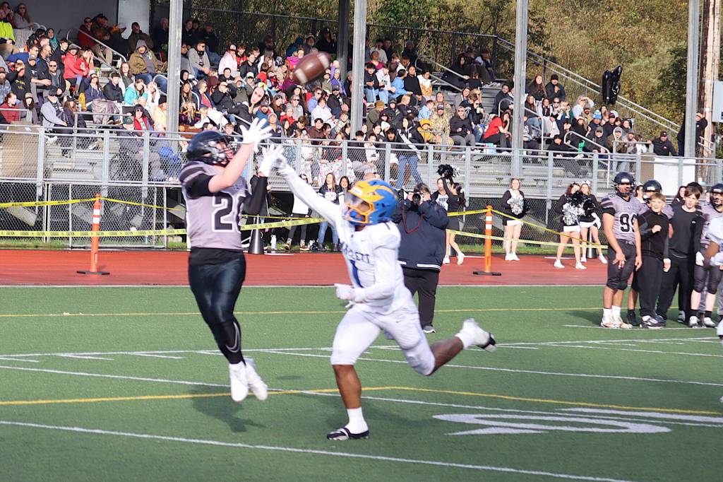 Juneaus Kurt Kuppert (20) catches a 30-yard touchdown pass from Jayden Johnson during the first half of Saturdays game against Bartlett High School at Adair-Kennedy Memorial Park. (Mark Sabbatini / Juneau Empire)