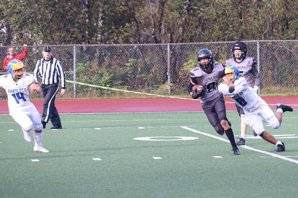 Daniel Campbell (8) runs back an interception for the Juneau Huskies late in the second quarter of Saturdays game against Bartlett High School at Adair-Kennedy Memorial Park. (Mark Sabbatini / Juneau Empire)