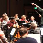 Christopher Koch guides the Juneau Symphony through a concert rehearsal at Juneau-Douglas High School: Yadaa.at Kalé on May 30, 2023. He departed as music director of the symphony last month. (Mark Sabbatini / Juneau Empire file photo)
