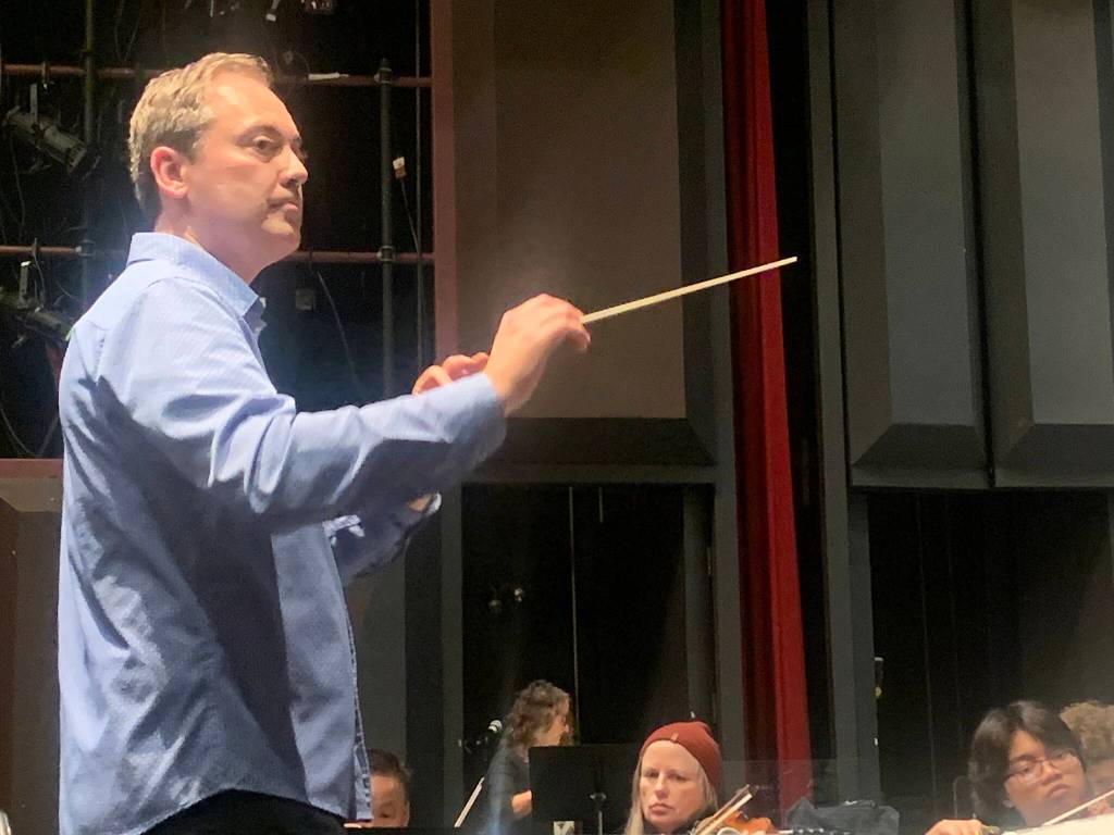Dwayne Corbin conducts the Juneau Symphony during a rehearsal Tuesday for this weekends concerts at Juneau-Douglas High School: Yadaa.at Kalé. (Mark Sabbatini / Juneau Empire)