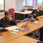 Juneau Board of Education President Deedie Sorensen (left) and Vice President Emil Mackey (right), with his son Emil Mackey IV between them, listen to a presentation during a school board retreat at Juneau-Douglas High School: Yadaa.at Kalé on Saturday, Sept 28. Recall votes for both board members are failing in the initial vote tally in this years municipal election. (Mark Sabbatini / Juneau Empire)