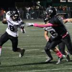 Juneau senior Caleb Ziegenfuss (16) uses a block by senior Hayden Aube (2) to run past Colony senior Tegan Olson (7) during the Huskies 42-6 win over the Knights on Friday in Palmer. (Klas Stolpe / Juneau Empire)