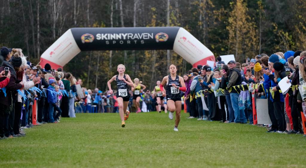 Juneau-Douglas High School: Yadaa.at Kalé freshman Nevah Lupro (278) and sophomore teammate Kaia Mangaccat (279) race during the Division I 2024 ASAA cross-country running state championships Saturday on the Bartlett High School Trails in Anchorage. (Klas Stolpe / Juneau Empire)