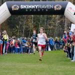Bettye Davis East Anchorage sophomore Katahdin Staples (213) sprints to the finish ahead of Juneau-Douglas High School: Yadaa.at Kalé sophomore Erik Thompson (285) in the Division I boys 2024 ASAA cross-country running state championships Saturday on the Bartlett High School Trails in Anchorage. (Klas Stolpe / Juneau Empire)