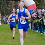 Petersburg junior Gaje Ventress (413) leads classmate Alex Holmgrain (407) to the finish of the Division III boys 2024 ASAA cross-country running state championships Saturday on the Bartlett High School Trails in Anchorage. (Klas Stolpe / Juneau Empire)